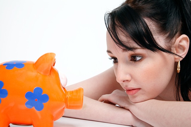 Girl staring at piggybank